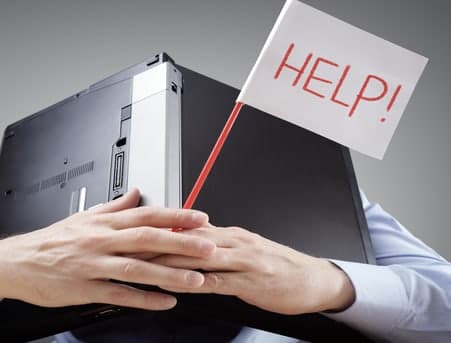 A stressed business owner holding a laptop and a HELP flag